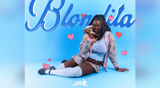 Woman wearing the Blondita fashion collection and holding a dog