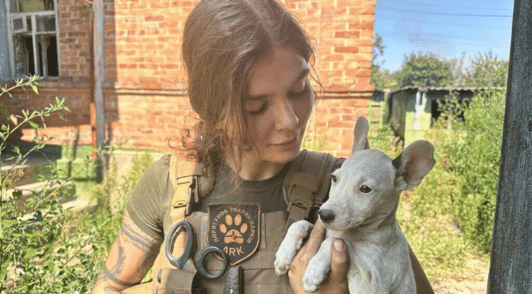 woman holding a puppy
