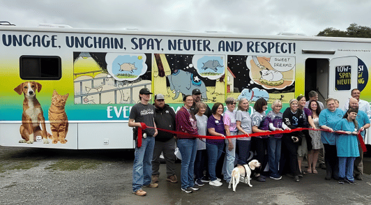 people standing in front of the new mobile spay and neuter clinic