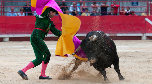 bull and matador in bullfighting arena