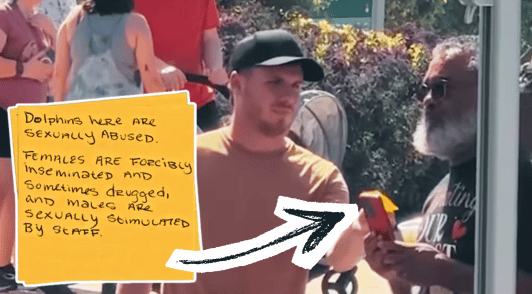 man handing someone a post it note with a message about SeaWorld