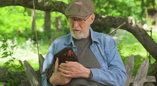 James Cromwell holding a hen