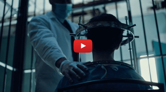 person with metal screwed into head in a laboratory cage