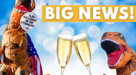 person dressed up as a dinosaur next to person holding sign thanking the president for cutting animal experiments