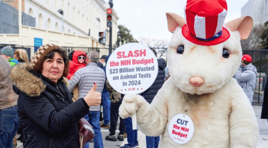giant mouse holding sign with a message to Trump