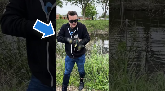 man holding duck near water