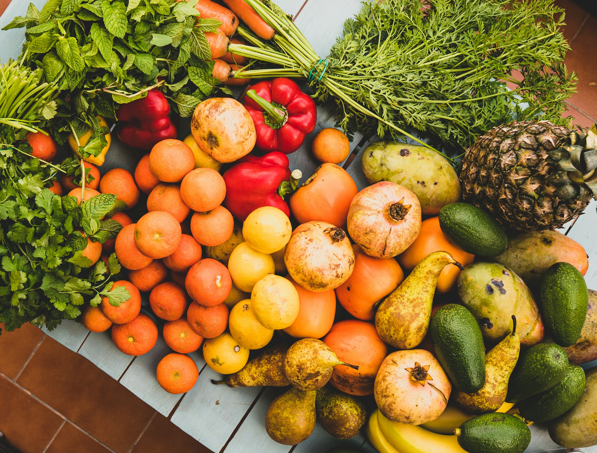 Photo of a collection of various fruits and vegtables on a table.