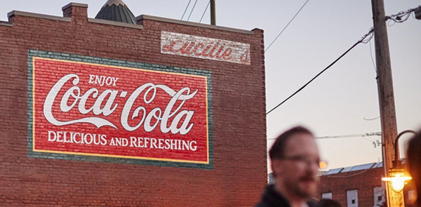 Coca-cola sign painted on the side of a builidng