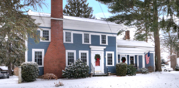 blue house in the snow