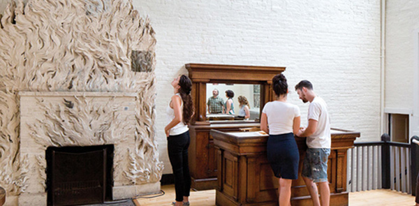 Woman looking up at a fireplace