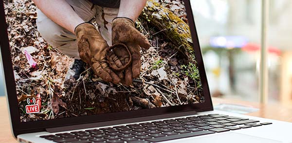 Laptop displaying an image of person in the dirt