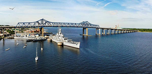 battleship near a bridge