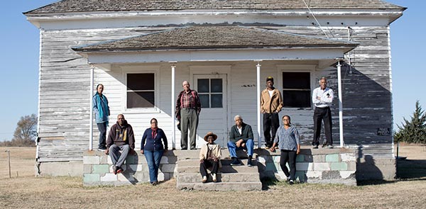Collection of people sitting on a building stoop