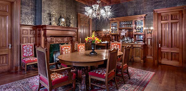 Dining room interior with wood paneling and dining room table