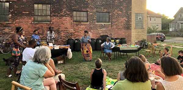 A group of people outside of a brick building
