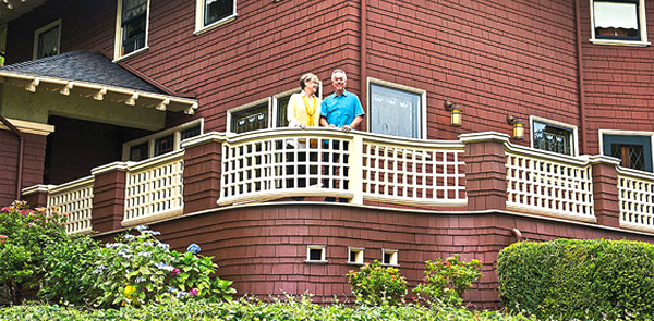 couple standing together outside of a house