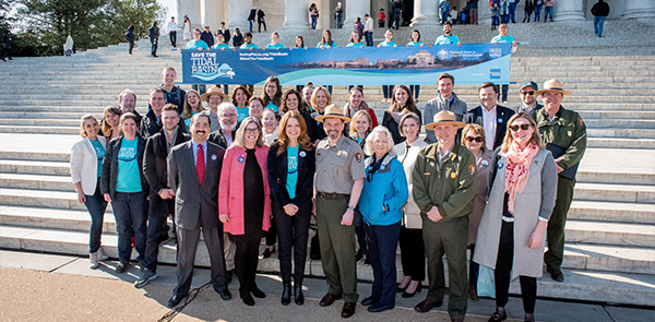 Smiling group of people standing on the steps of the Jefferson Memorial