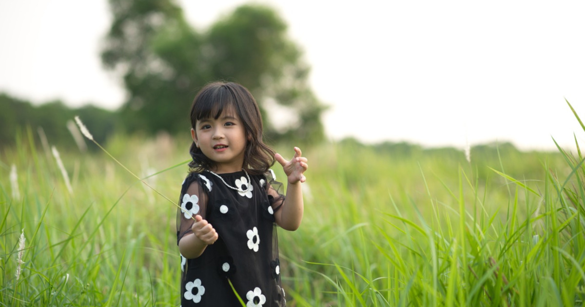 young girl in grassy meadow