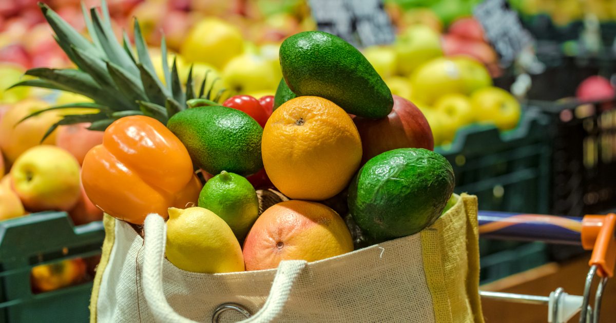 healthy foods and produce in a reuseable bag at a grocery store