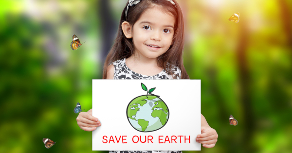 young girl surrounded by butterflies in a forest with a sign stating SAVE OUR EARTH