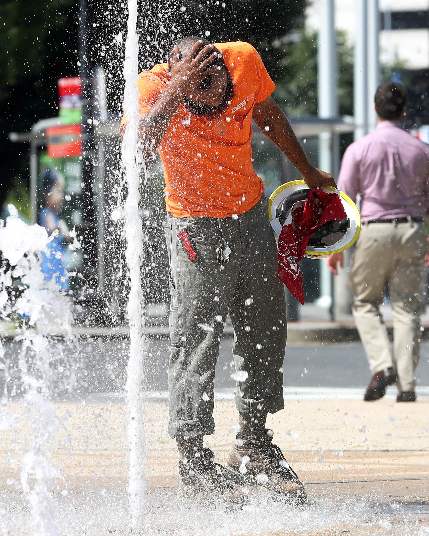 A man takes his construction hat off to cool down on a hot day