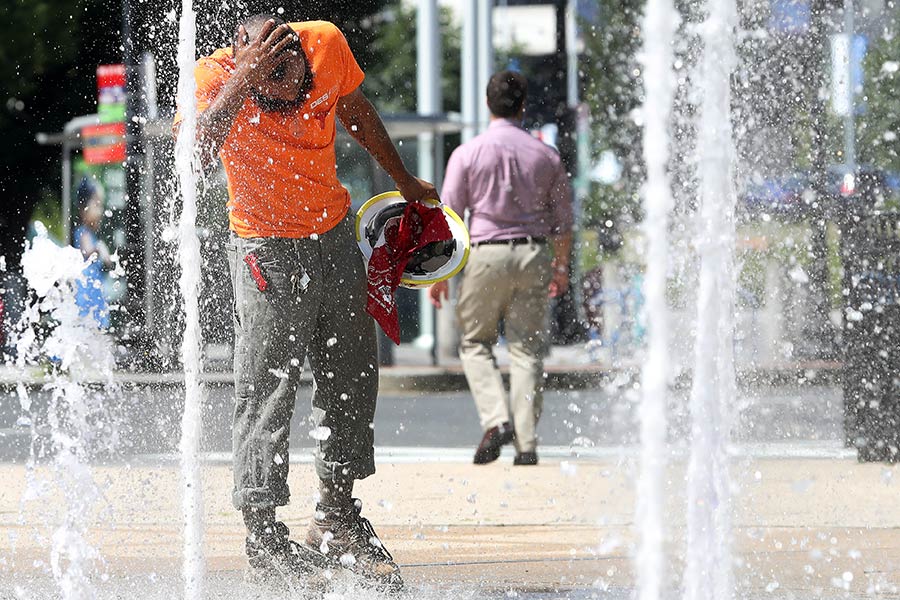 A man takes his construction hat off to cool down on a hot day