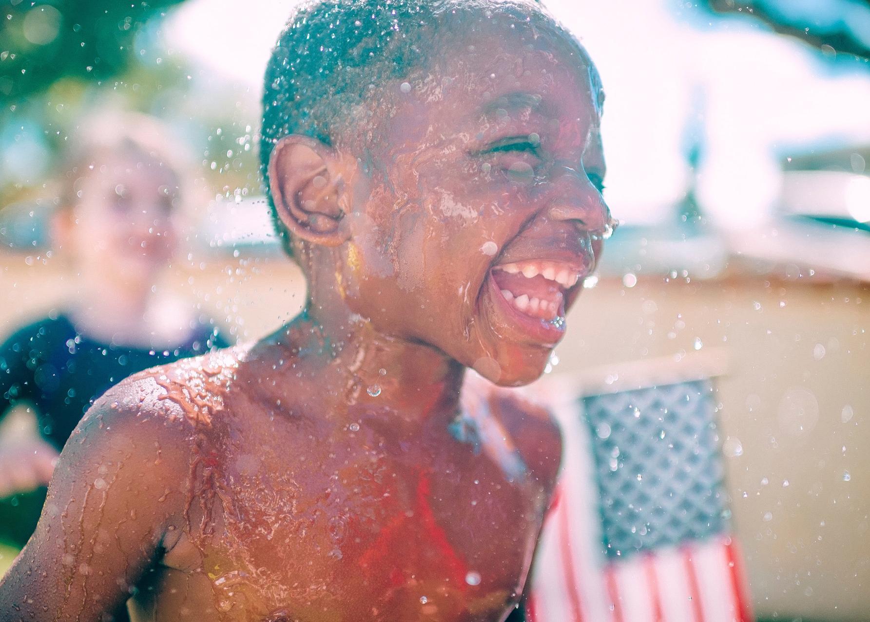 Happy child playing in water