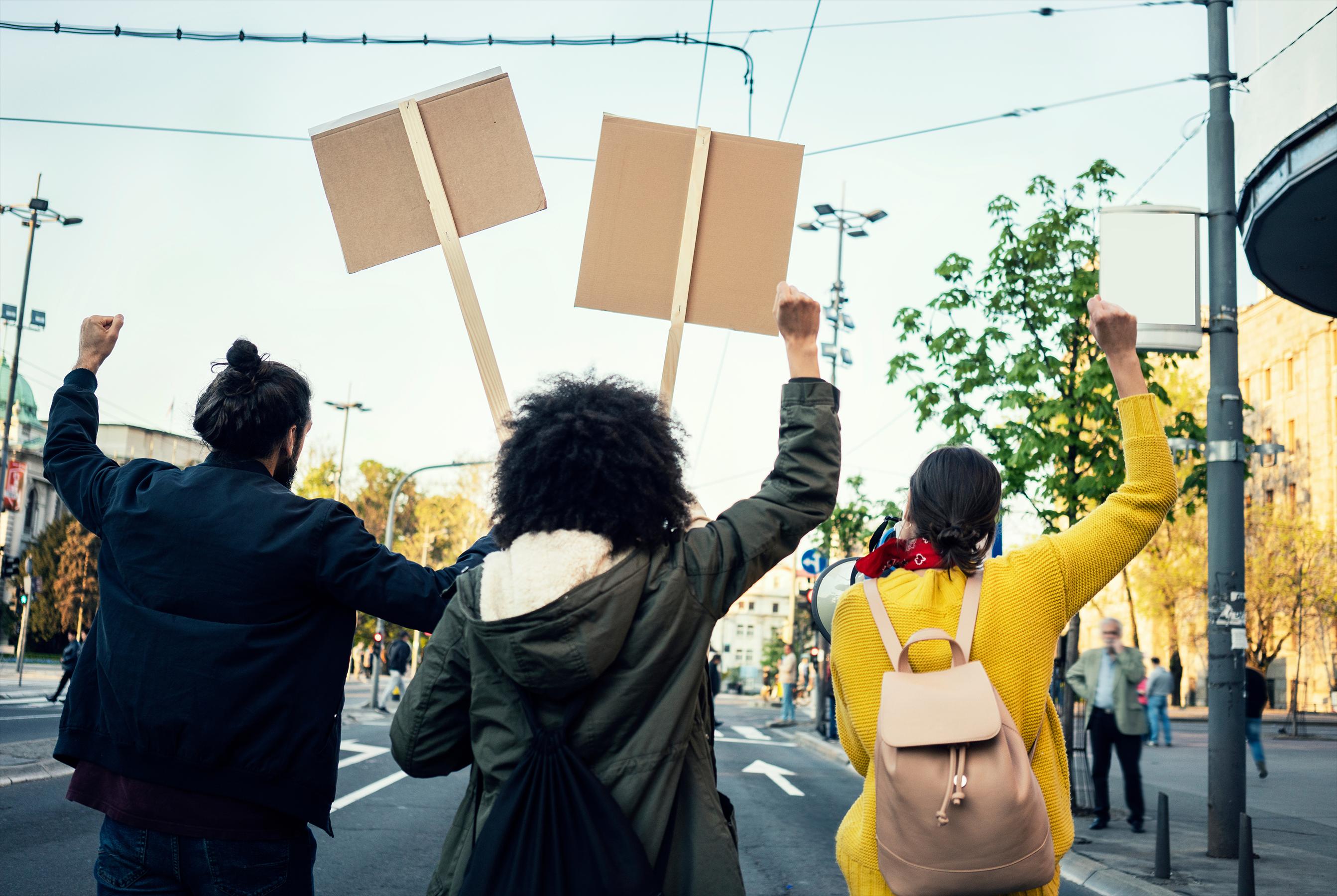 People carrying signs at demonstration