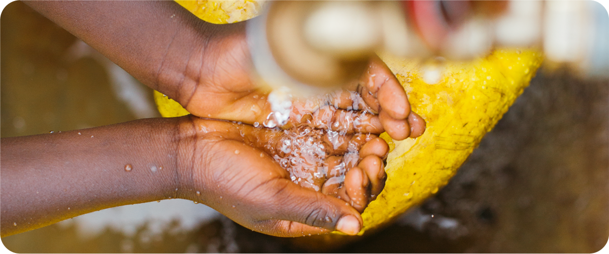 Clean water pours over cupped hands.