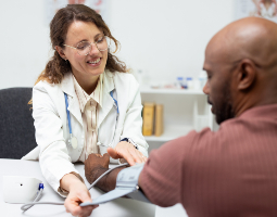 Doctor checking a patient’s blood pressure.