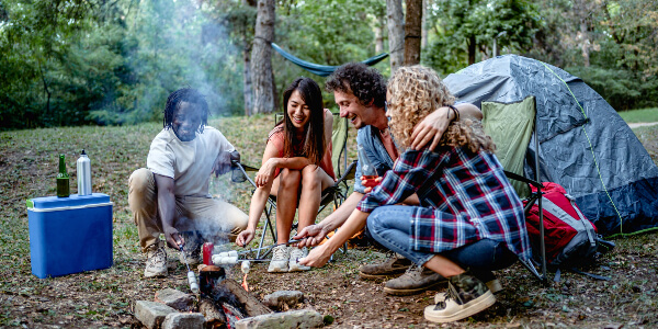 Group of friends sitting around a campfire