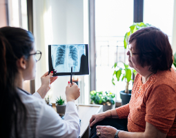 Physician reviewing a lung scan with her patient