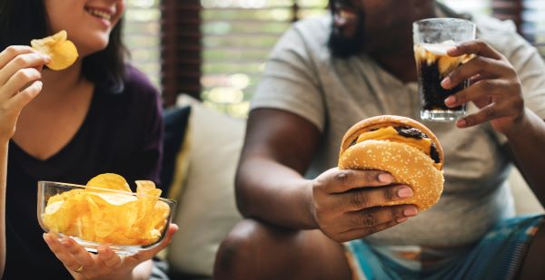Two people enjoying ultra-processed food