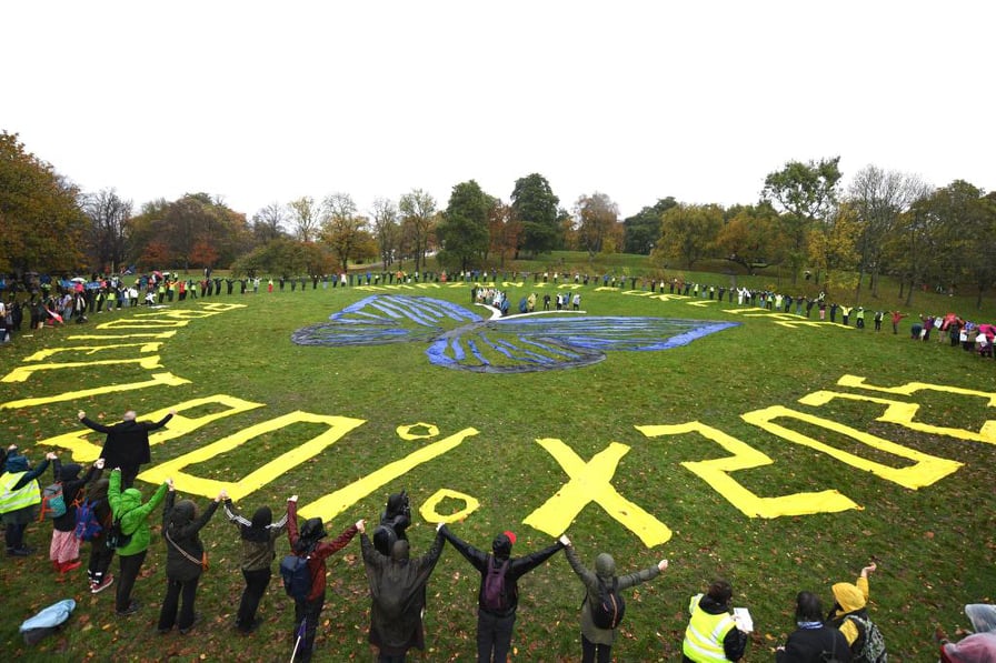 human banner action in Glasgow to protect 80% of the amazon by 2025