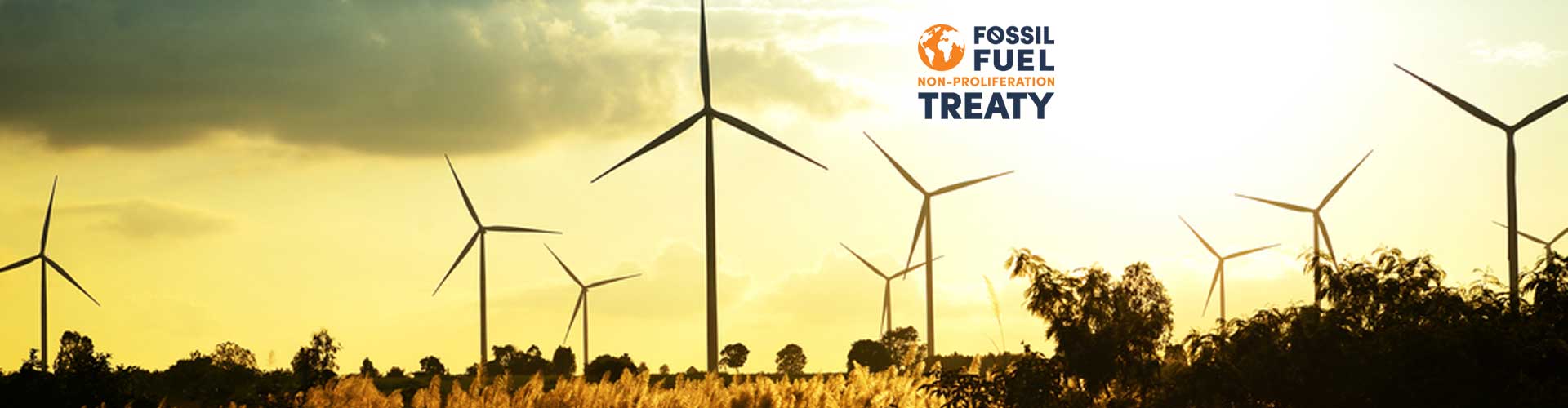 Renewable energy turbines overlaid with the Fossil Fuel Non-Proliferation Treaty logo