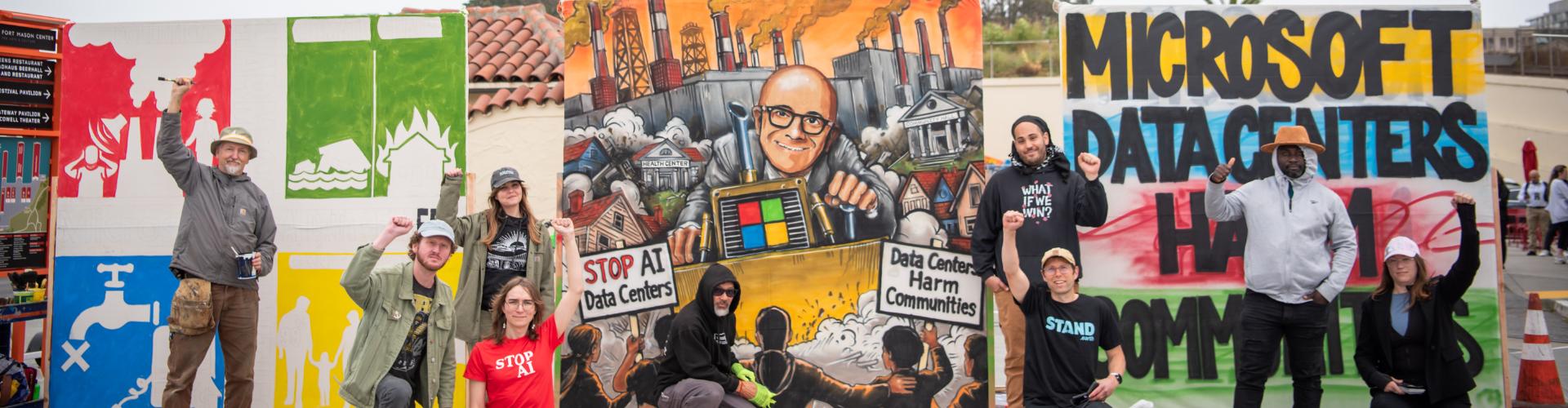 photograph of activists in front of banners that read "microsoft data centers harm communities"