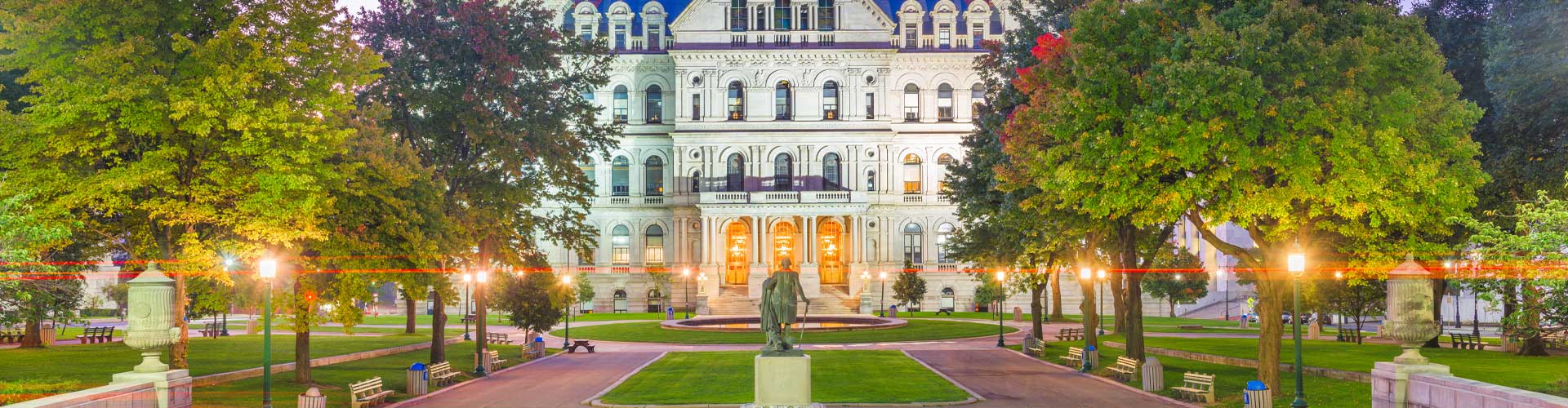 the NY State Capitol building flanked by trees