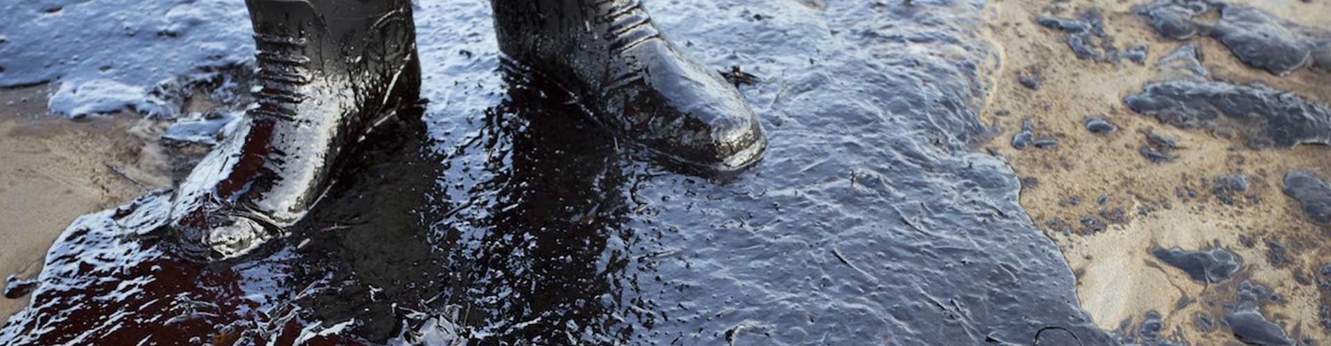 Boots standing on top of an oil slick