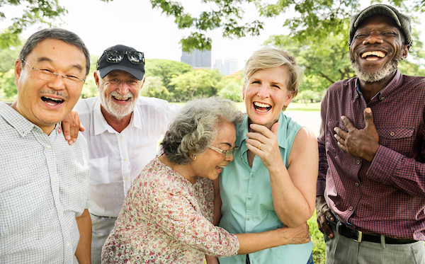 A group of older adults laughing and enjoying each other. 