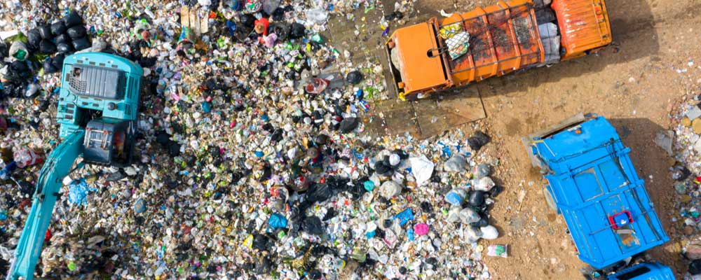 Overhead view of landfill with garbage trucks