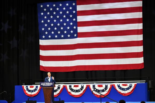 Jay Jones in front of a flag
