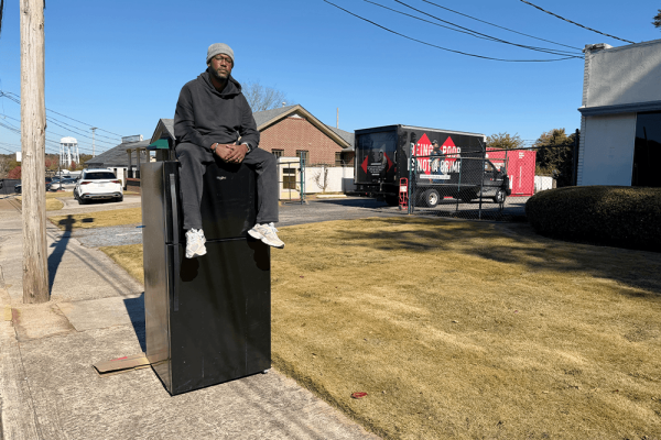 Terence Lester on top of his fridge