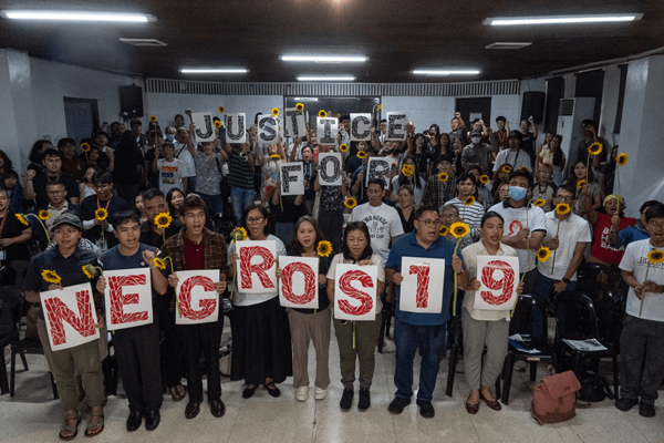 Human rights advocates and families of the victims of the Negros 19 gather to spell out ‘Justice for Negros 19’