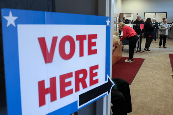 A sign reading 'VOTE HERE'
