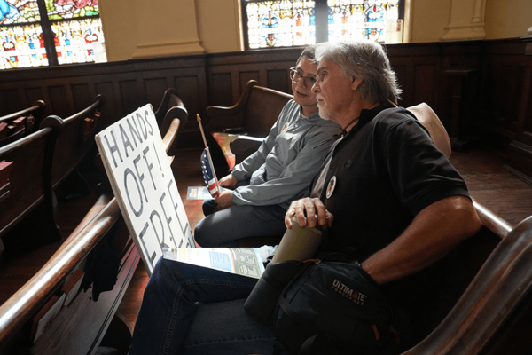 People attend an election training event in Saint Mark United Methodist Church amid a “No Kings” protest.