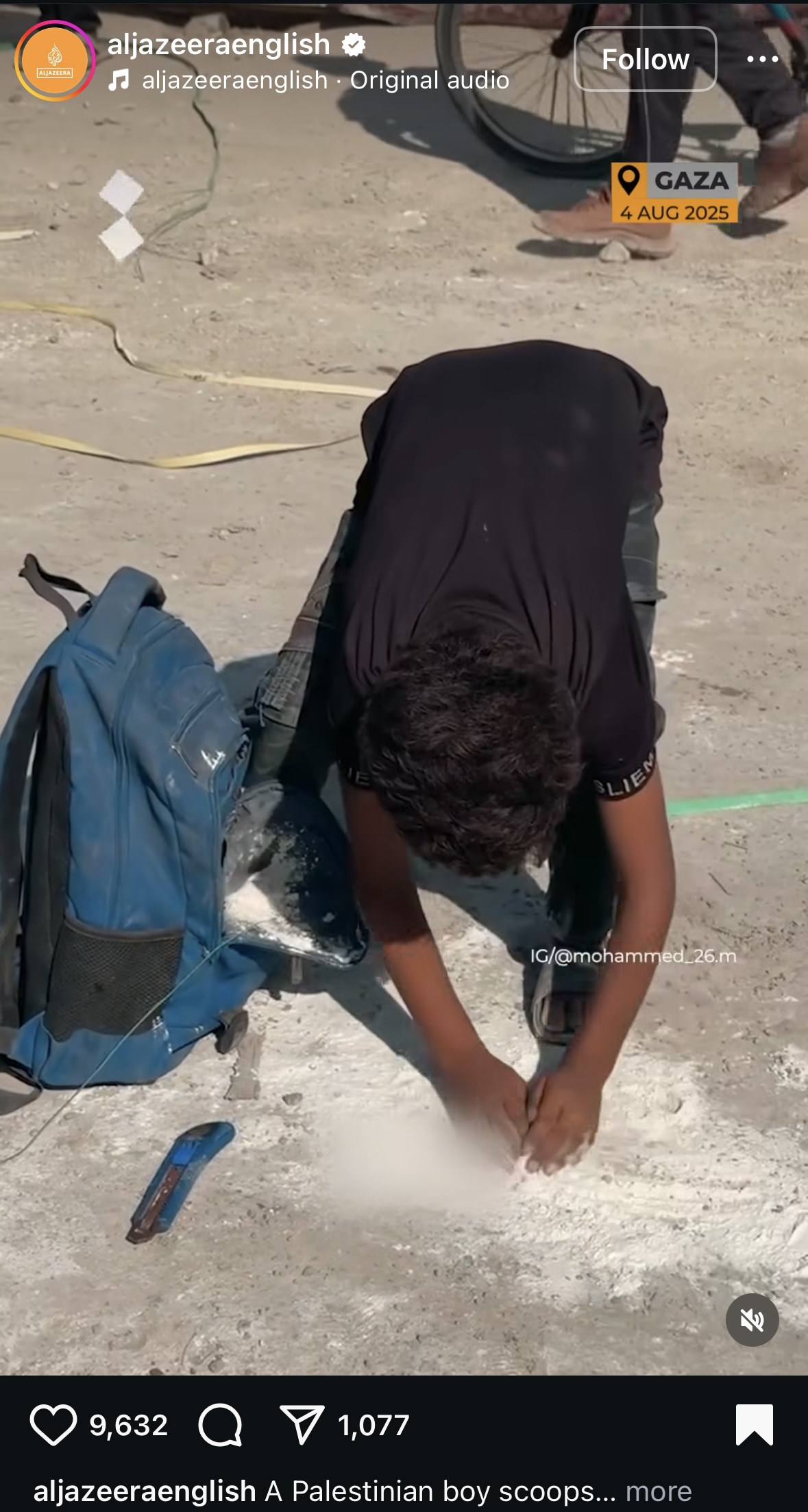 A Palestinian boy collects spilled flour off the ground