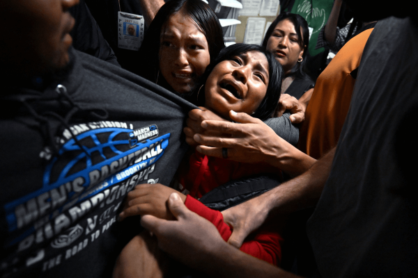 A migrant from Ecuador is taken by ICE