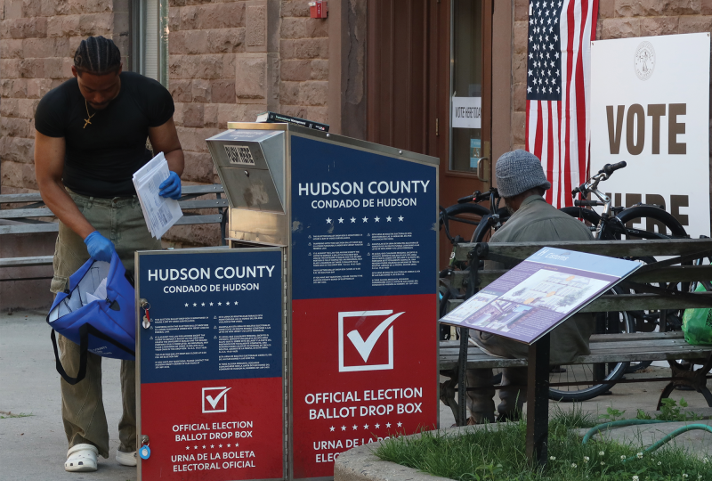 Poll worker collecting ballots from 