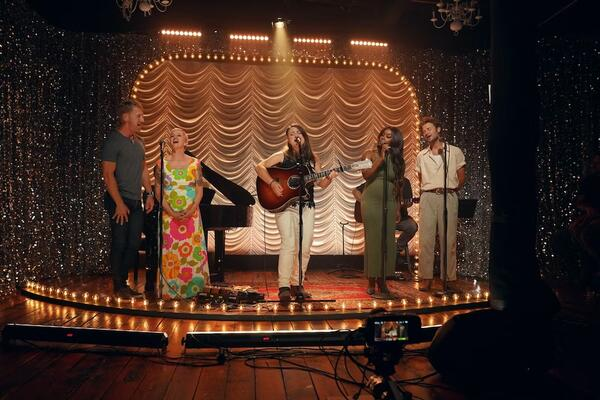 A group of former CCM stars perform together on a stage