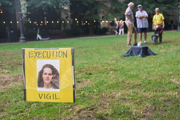 A sign for a vigil for Christa Pike